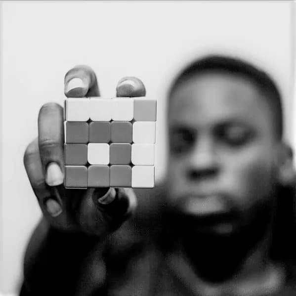 A team member holding up a partly solved puzzle cube.